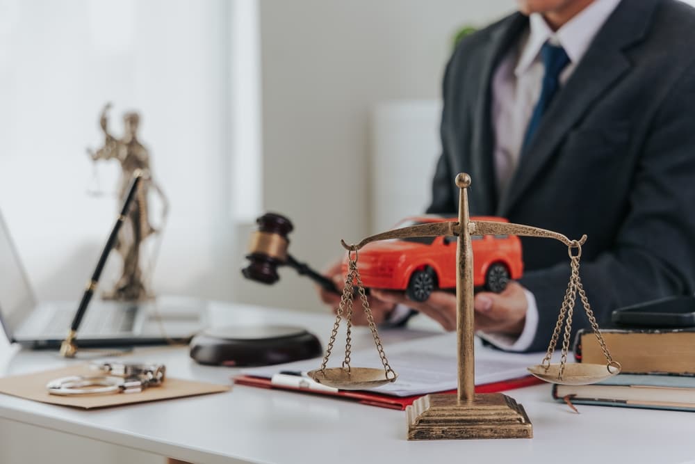 Notebook, phone, and folder used for evidence gathering after a vehicle collision