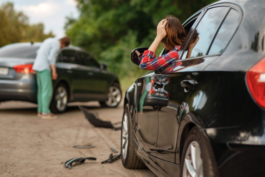 Person at a kitchen table organising paperwork after a vehicle collision
