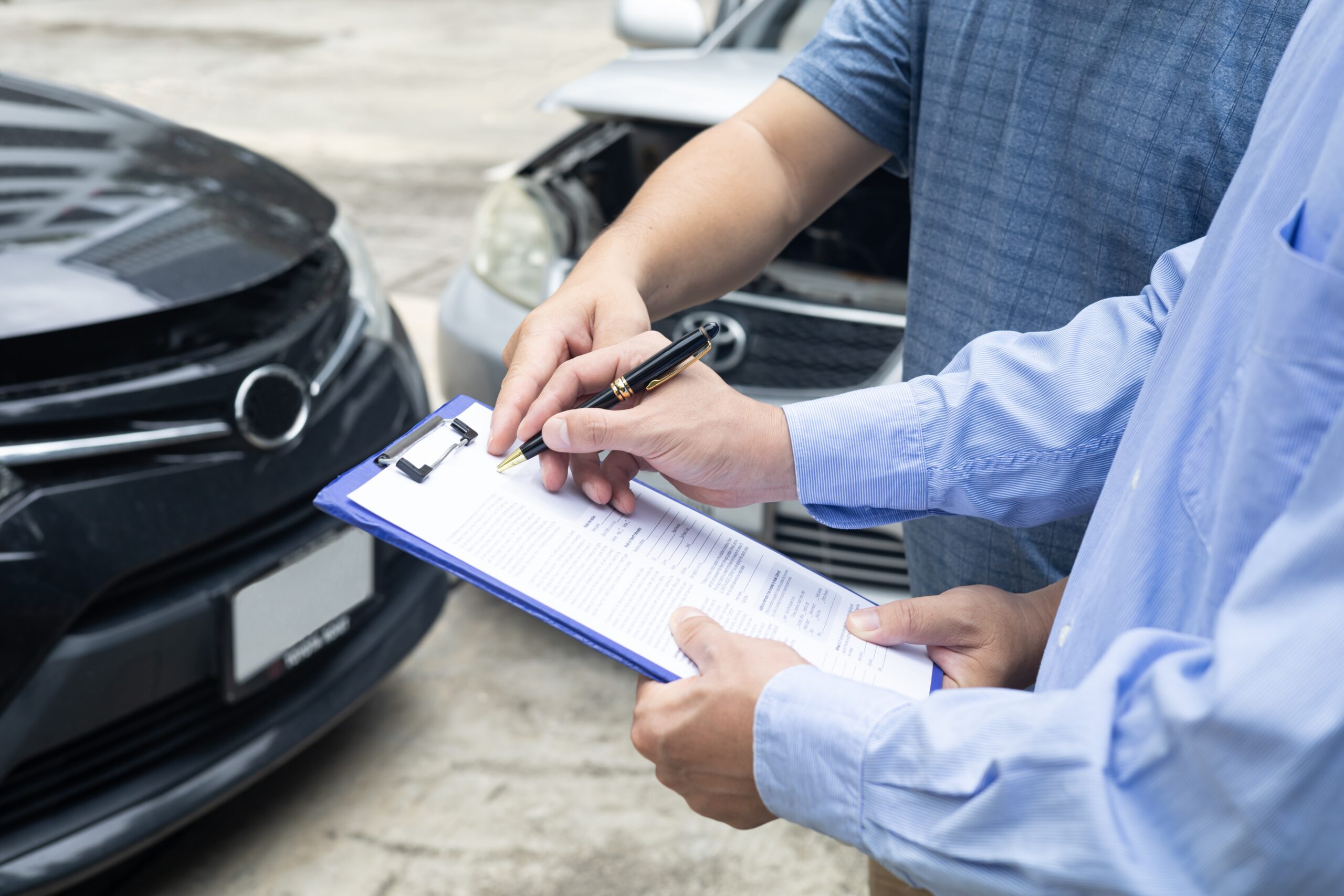 Adjuster reviewing crash damage paperwork and forms